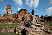 Ayutthaya, Thailand. Wat Mahathat, a Buddha statue of the gallery enclosing the collapsed central prang. 